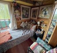 A cottage with rich decorations, a comfortable sofa, and decorative paintings on the walls.