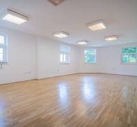 Building on Halatova Street in Poprad with a parking lot and a view of the mountains.