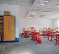 Office spaces with computers in the building, decorated with wooden doors and shelves.