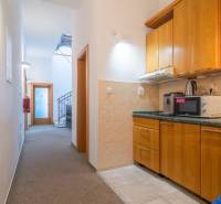 Interior in a building with wood-patterned flooring and a table.
