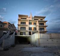 The exterior of a building in Primošten, suitable for a 3-room apartment, at dusk.
