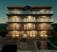 Evening view of an illuminated building with a pool in the city of Primošten.