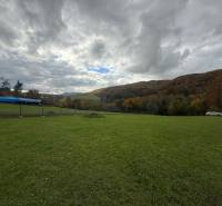 Spacious residential plots with greenery on Zbora Street, Púchov, surrounded by hills.