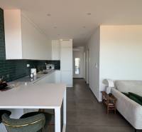 The kitchen of the villa with green tiles and a counter, combined with a relaxation area.