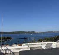 Sea view from the villa in Trogir. Terrace with loungers and glass railing.