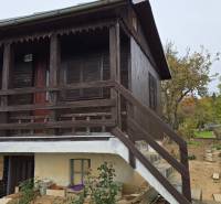 Wooden cottage with a garden and trees on A. Hlinka Street in Zvolen.