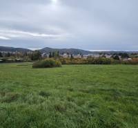 A view of the meadow and distant hills from the gardens in Zvolen on A. Hlinka Street.