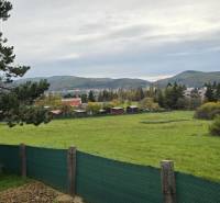 Gardens in Zvolen on A. Hlinka Street with a view of the hills and houses.