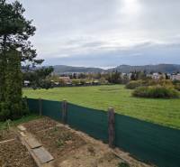 Gardens in Zvolen on A. Hlinka Street with a view of the hills and the housing estate in the background.