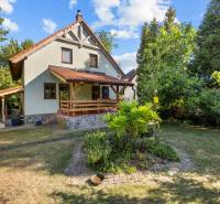 A family house on Senecká Street in Pezinok surrounded by a garden with trees.