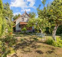 A family house on Senecká Street in Pezinok, surrounded by a garden with fruit trees.
