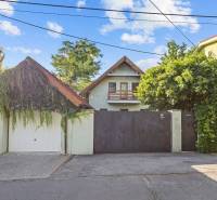A family house on Senecká Street in Pezinok, with a gate and greenery in the surroundings.