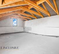 Ceiling with wooden beams and a window in commercial premises.