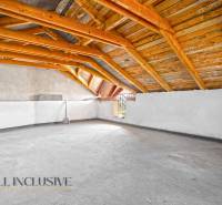 Attic commercial spaces with wooden beams and plenty of space for use.
