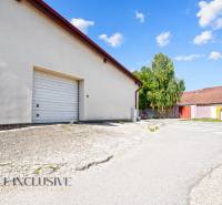 Paved area with a garage in commercial premises in Dunajská Streda on a sunny day.