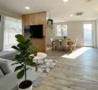 Living room in a family house with a wooden decor floor and stylish seating.