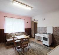 Kitchen in a family house with a dining table, stove, and cooker.