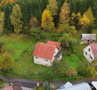 A hillside with a family house in Veľké Rovné, surrounded by forested nature.