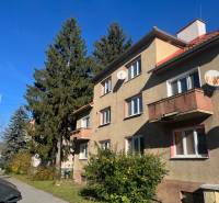 Apartment building on 9th May Street in Banská Bystrica, surrounded by trees and satellite dishes.