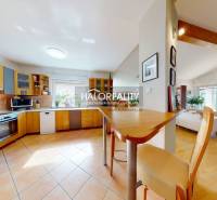 Kitchen and living room with wood-patterned flooring in a family house.