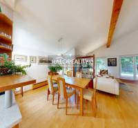Dining room with a large table and a wooden decor floor in a family house.