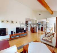Living room of a family house with a wooden decor floor, television, and glass display cabinet.