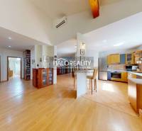 Interior of a family house with a wooden decor floor and a spacious kitchen.