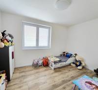 Children's room in a family house with a wooden decor floor, lots of toys.