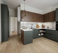 A spacious room with a wooden decor floor in a 2-room apartment.