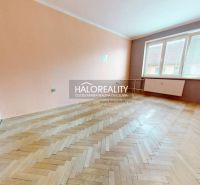 A spacious room in a 2-room apartment with a wooden decor floor.