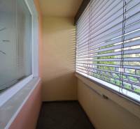 A balcony with tiles and blinds in a 1-bedroom apartment on Popradská Street, Košice - West district.