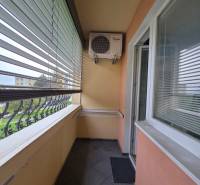 A balcony with blinds and air conditioning in a 1-room apartment.