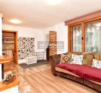 Interior with wood-patterned flooring and a sofa in Bernolákovo Gardens.