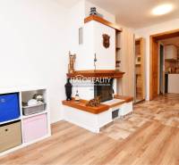 Interior with a fireplace and wood-patterned flooring, shelf with storage boxes.