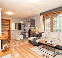 Living room with a sofa, wood-patterned flooring, and accessories in the Gardens.