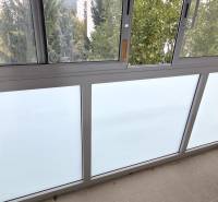 A glazed loggia in a 3-room apartment with a view of greenery.