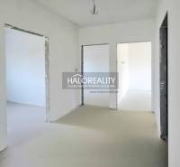 An empty room in a family house with unfinished walls and floor.