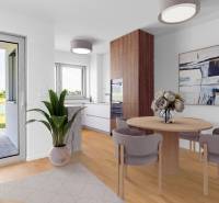 Dining area with a round table, wooden decor flooring, living space with greenery.