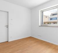 A room in a 4-room apartment with a wooden decor floor and a large window.