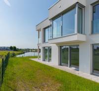 Exterior of a 4-room apartment in Kittsee, Am Seepark by the water surrounded by green nature.