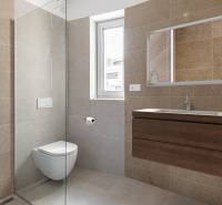 Bathroom with a shower in a 4-room apartment, tiles in natural tones, wall mirror.