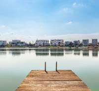 Wooden pier by the lake with a view of the properties in Kittsee, Am Strandbad.