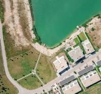 Aerial view of the streets Am Seepark in Kittsee near the lake and buildings.
