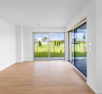 Living room with light flooring and large windows in a 4-room apartment.