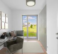 A study in a 4-room apartment with a view of the garden and a floor with a wooden decor.