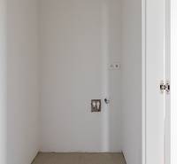 An empty space with outlets and white walls in a 4-room apartment.