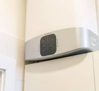 Electric water heater on the wall in a 2-room apartment, shown up close.