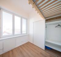 A bright room in a 2-room apartment with large windows and a built-in wardrobe.