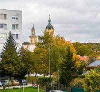 A view of the church towers and a residential building in Modra on Komenského Street.