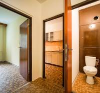 In the 3-room apartment, you can see the kitchen, toilet, and a room with a wooden decor floor.